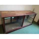 A 19th century mirror back counter unit, having a glazed front, and four doors opening to the