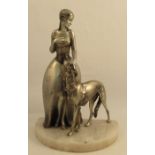 A Lorenzl patinated spelter model, modelled as a woman wearing a flower dress with a Borzoi dog,