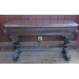 A 17th century style oak side table, fitted with a frieze drawer, with lions masks, and dolphin