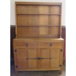 Mouseman, Robert Thompson of Kilburn, an oak dresser, with closed boarded rack over, fitted with two