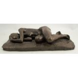 A bronze effect model, of a sleeping nude female on a rug, 14ins x 7.75ins x 3.5ins