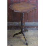 A 19th century octagonal topped elm country wine table, raised on a part ring turned column,