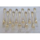 A set of eleven silver Georgian/Victorian dessert forks, in the fiddle, thread and shell pattern,