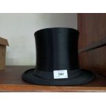 A continental silk collapsible top hat, height 5.5ins, internal length 8ins x width 6.25ins.