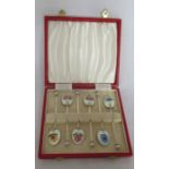 A cased set of six silver and enamel coffee spoons, the back of each bowl decorated with a different