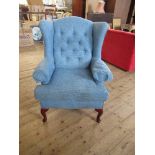 A WING BACK ARM CHAIR IN BLUE UPHOLSTERY, WITH FIRE LABELS, BEARING LABEL MULTIYORK, TOGETHER WITH A