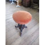 A Victorian walnut revolving piano stool