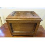 An oak box, with fielded panels, with rising lid, raised on bun feet, height 16ins, width 19ins