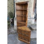 An Ercol freestanding corner unit, height 72ins, width 28ins together with a corner unit