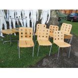 A collection of stacking chairs and tables and three tables
