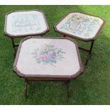 Three glass top tilting tables, the tops set with tapestry pictures, with oak frame and base