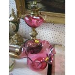 A Victorian oil lamp, with cranberry shade, together with a cranberry decanter