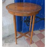 A 19th century painted satinwood oval table, decorated with flowers and musical instruments, the