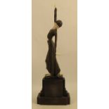 An Art Deco style figure, of a woman, in metal and simulated ivory, height to include base 16.25ins