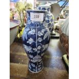 A 19th century Chinese vase, decorated with flowers and dragons to a dark blue ground, with