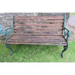 A 20th century wooden slat bench, with cast iron ends, width 50ins, height 31ins, depth 24ins