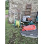 A collection of tools, ladder, wheel barrow etc