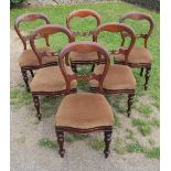 A set of six Victorian mahogany balloon back dining chairs, with turned front supports