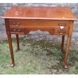 A 19th century mahogany lowboy, fitted with one long over two short drawers, raised on pad feet,