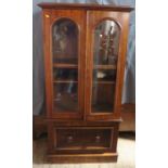 A Victorian mahogany cabinet, the pair of glazed doors revealing adjustable shelves, over a drawr