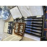 Four cases of hallmarked silver teaspoons, table knives and spoons
