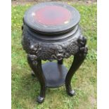 An Oriental hardwood jardinere stand, of circular form, with carved decoration, diameter of top