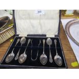 A cased set of six silver teaspoons and sugar tongs, Birmingham 1915