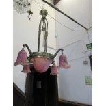 A light fitting, with pink shades