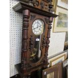 A 19th century Vienna style carved wall clock, with key and pendulum