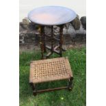 An oak folding circular table, together with a woven top oak stool