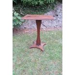 An Arts and Crafts style elm wine table, raised on shaped column