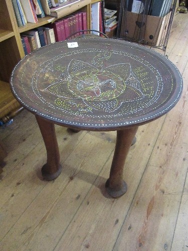 A tribal style table, with bead work decoration