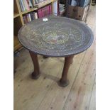 A tribal style table, with bead work decoration