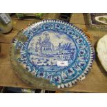 An antique Iznik style tinglazed earthenware plate, decorated with a central panel of a man in a