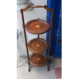 A mahogany folding cake stand, with paterea inlay, height 34ins