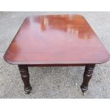 A 19th century mahogany dining table, raised on turned supports, 63ins x 43.5ins