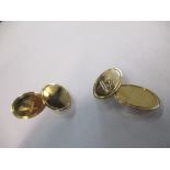 A pair of 9 carat gold Masonic cuff links, the one oval panel vacant, the other engraved with a