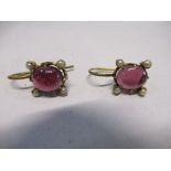 A pair of Victorian garnet earrings, the cabochon with seed pearls at each corner