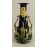 A Minton Secessionist two handled vase, decorated with flowers to a blue ground, height 9.