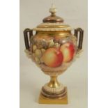 A Royal Worcester covered vase on a pedestal, decorated with hand painted fruit all around by