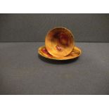 A Royal Worcester cabinet cup and saucer, decorated with hand painted fruit by Townsend and