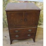 A 19th century mahogany commode, having two cupboard doors, over two drawers, raised on bracket
