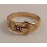 A 9 carat gold buckle ring, set with a ruby, finger size N, 2.6g gross