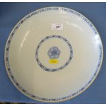 A Chinese saucer dish, decorated with blue bands around a central floral motif, having moulded body,