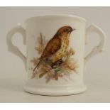 An English porcelain miniature porcelain loving cup, painted with a thrush to the front and leaves