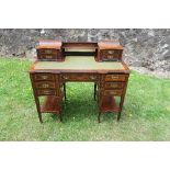 A late Victorian/Edwardian rosewood and satinwood inlaid writing desk, with leather inset, stamped