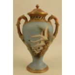 A Royal Worcester covered vase, decorated with swans to a powder blue ground, attributed to C H C