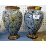 A pair of Doulton vases, by Frank Butler , decorated with flowers to a blue ground, impress mark