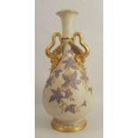A Royal Worcester gilded ivory vase, of baluster form, decorated with blue leaves and gilt buds,