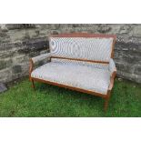 An Edwardian settee, with open arms, inlaid decoration, width 55ins, height 39ins